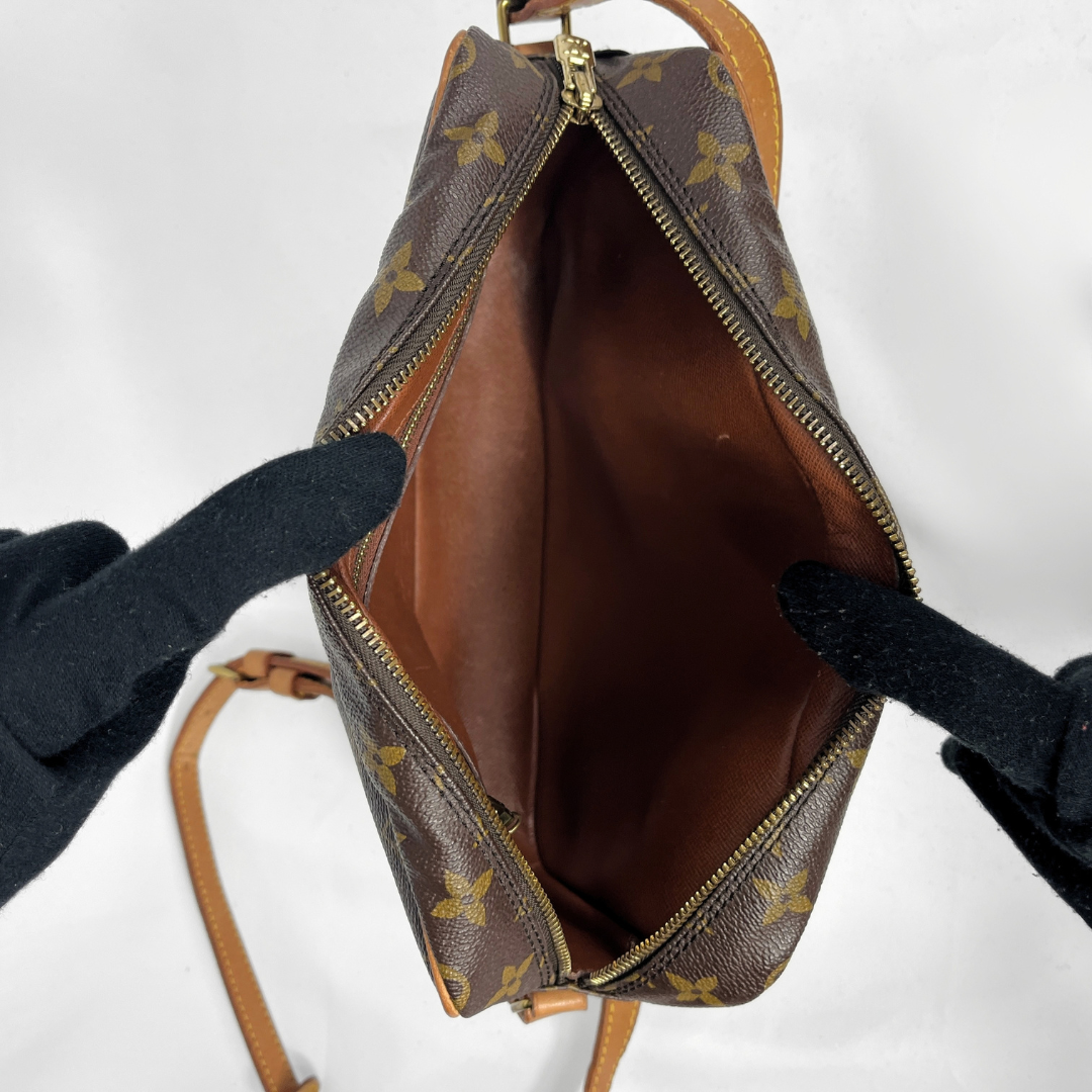 A Louis Vuitton monogram canvas shoulder bag in dark brown and tan, featuring the classic LV monogram pattern and tan leather trim, shown against a white background.