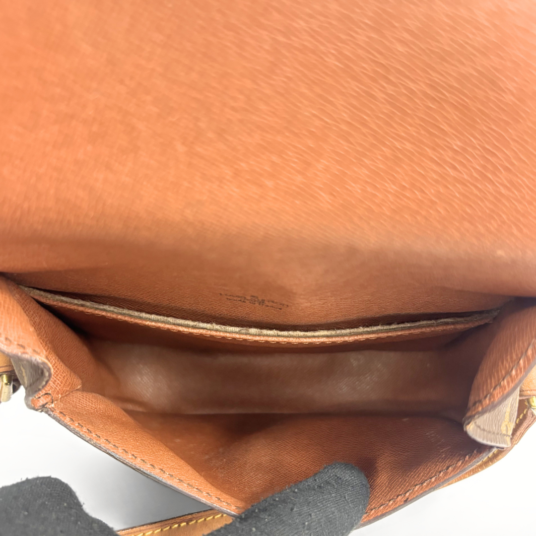 Louis Vuitton monogram handbag on a light gray background