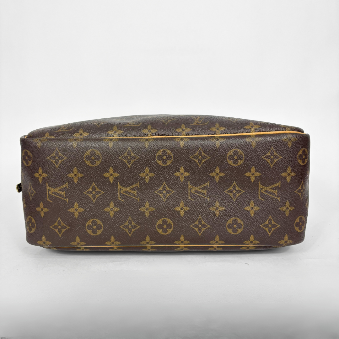 Designer handbag with monogram pattern on a white background