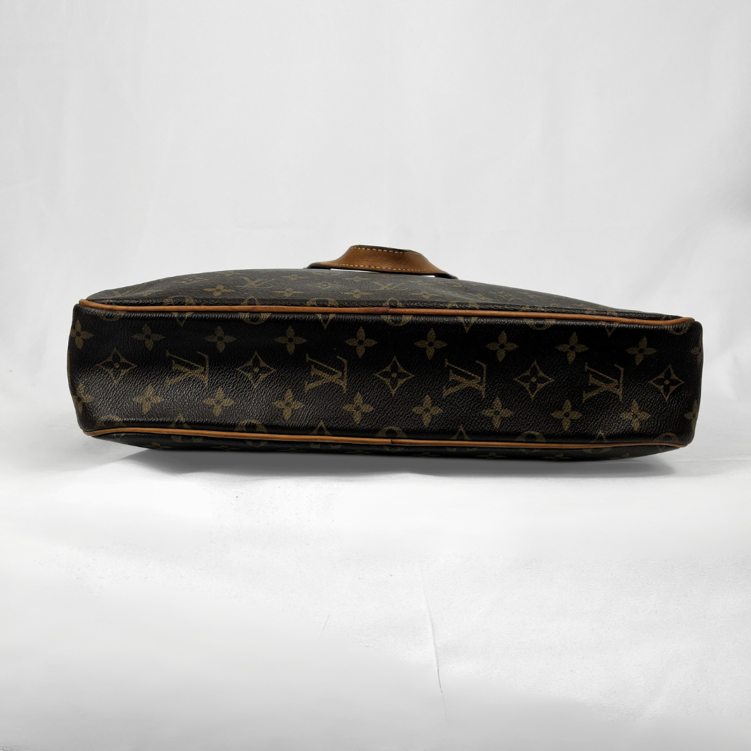 Louis Vuitton monogram canvas shoulder bag shown from the side profile against a white studio background.