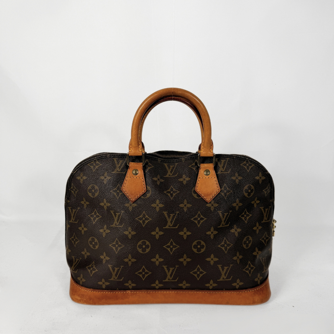 Louis Vuitton monogram canvas handbag with tan leather handles and trim, photographed against a plain white background.