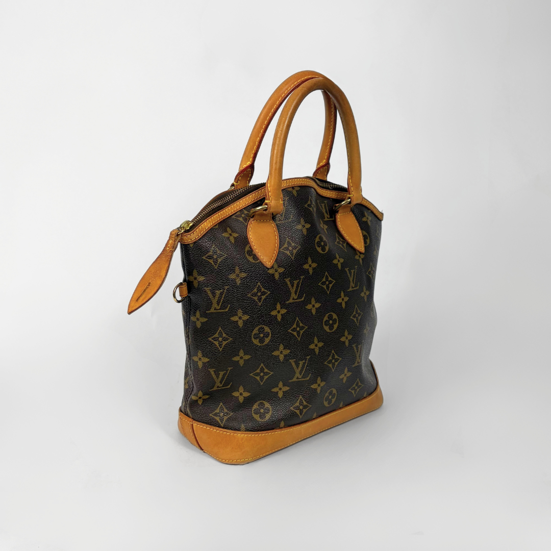 Designer handbag with monogram pattern on a white background