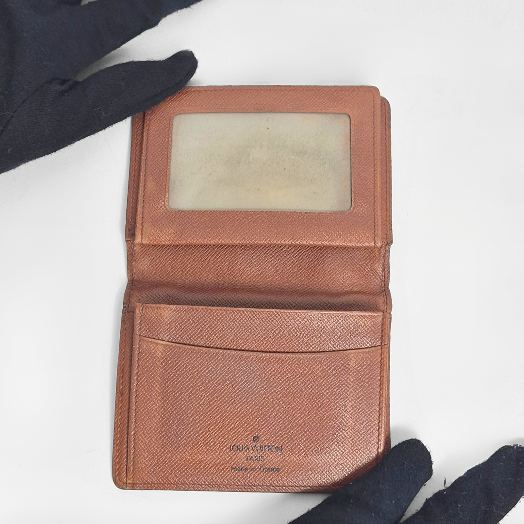 Brown leather wallet with a brand logo on a white background