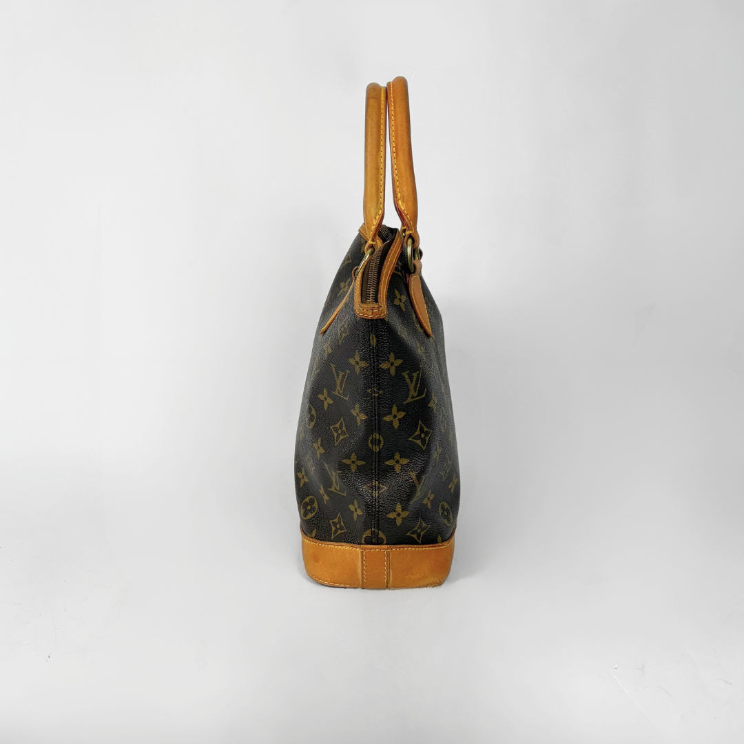 Designer handbag with monogram pattern on a white background