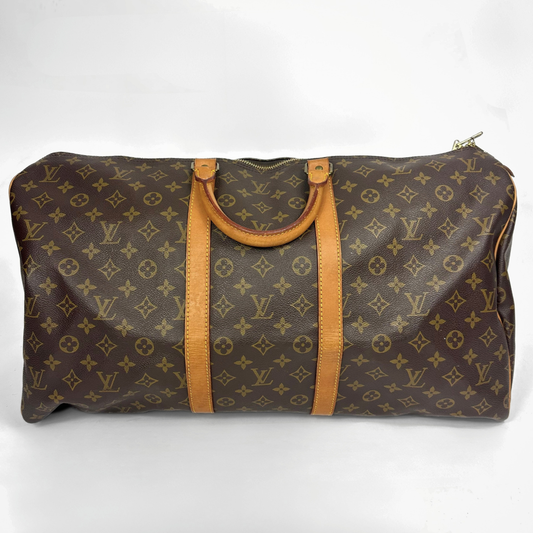 Brown travel bag with tan straps on a white background