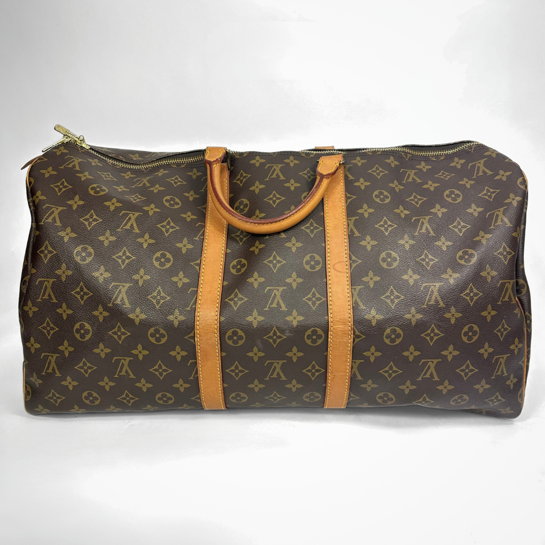 Brown travel bag with tan straps on a white background