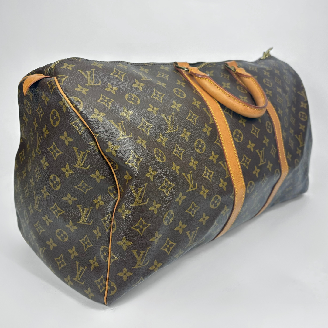 Brown travel bag with tan straps on a white background