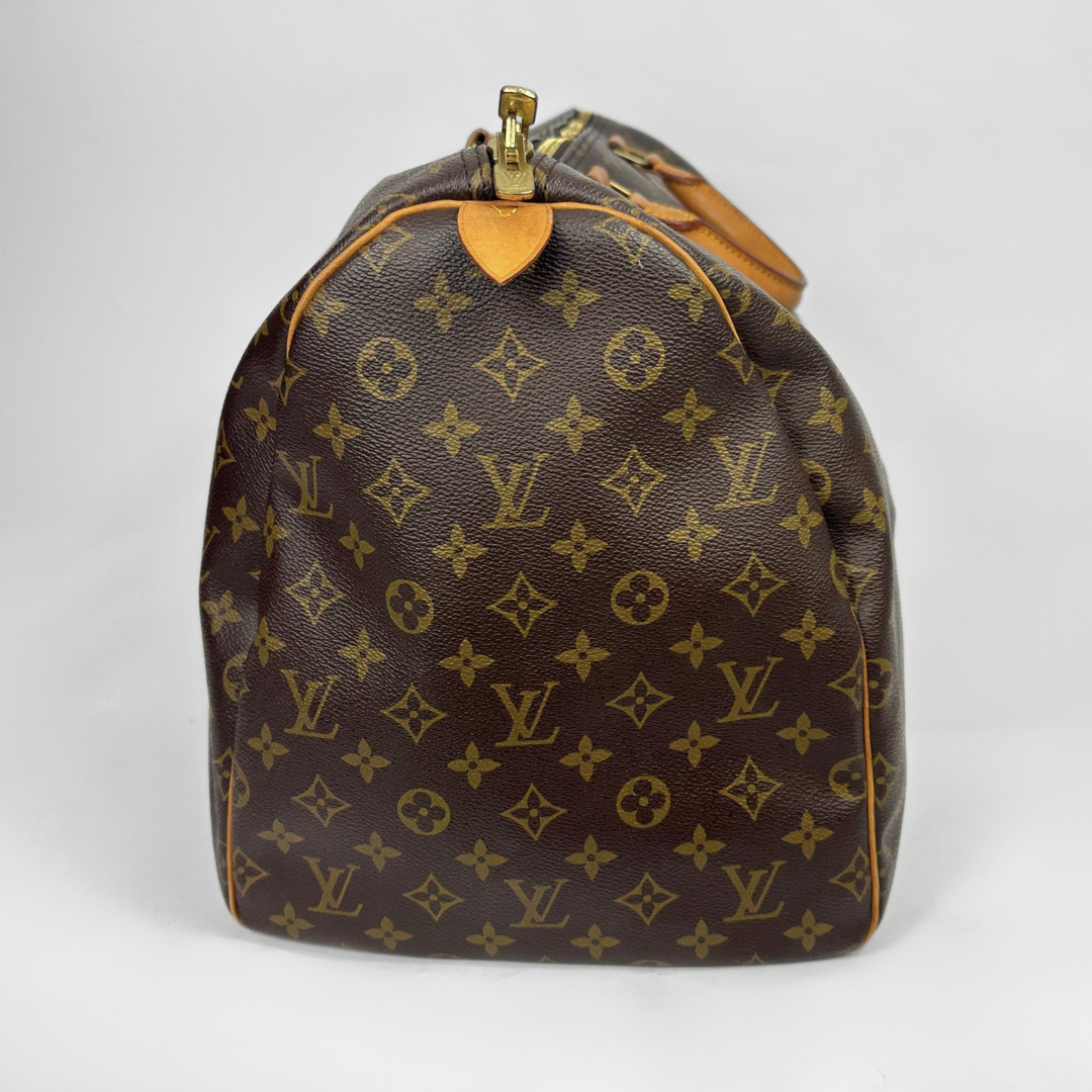 Brown travel bag with tan straps on a white background