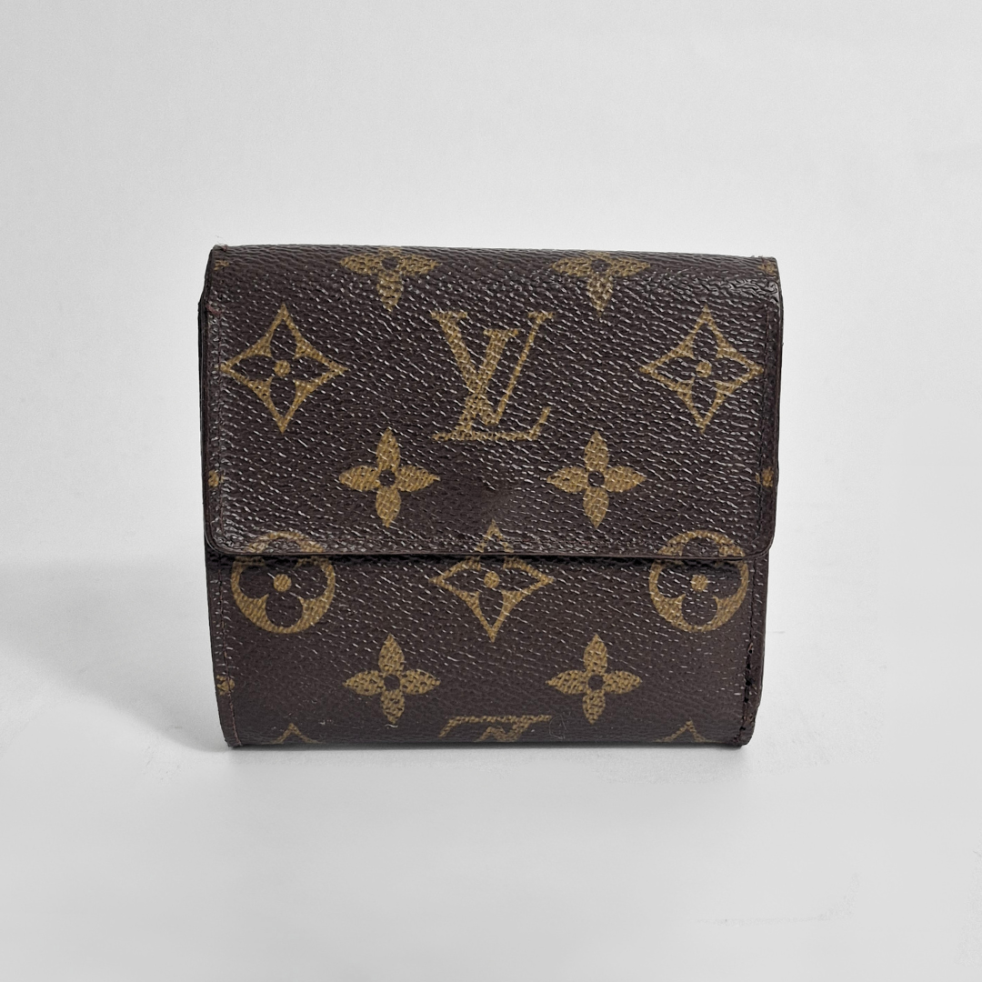 Louis Vuitton wallet with monogram pattern on a light gray background
