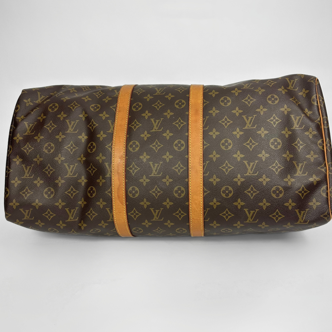 Brown travel bag with tan straps on a white background