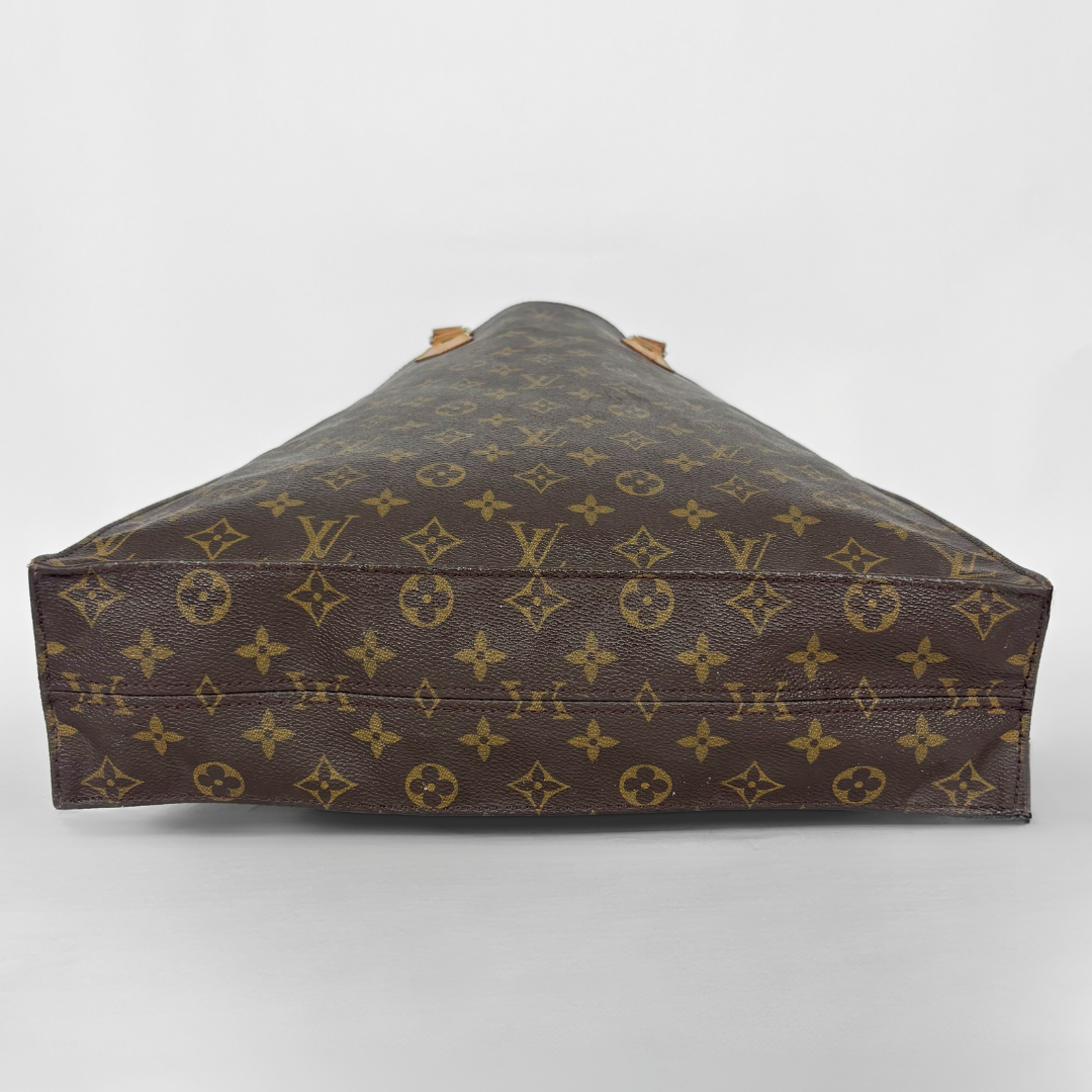 Brown leather bag with monogram pattern on a white background