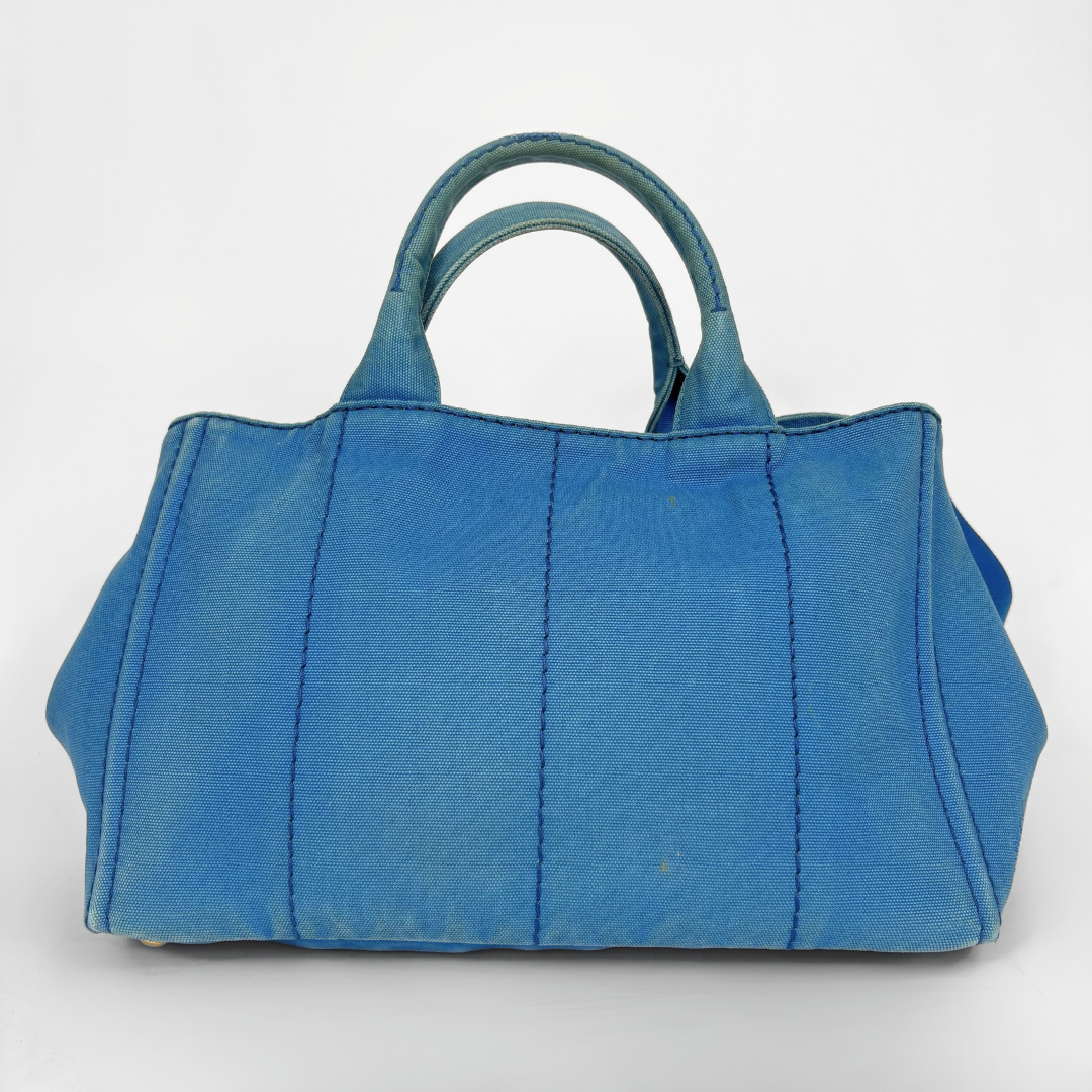 Blue Prada handbag on a white background