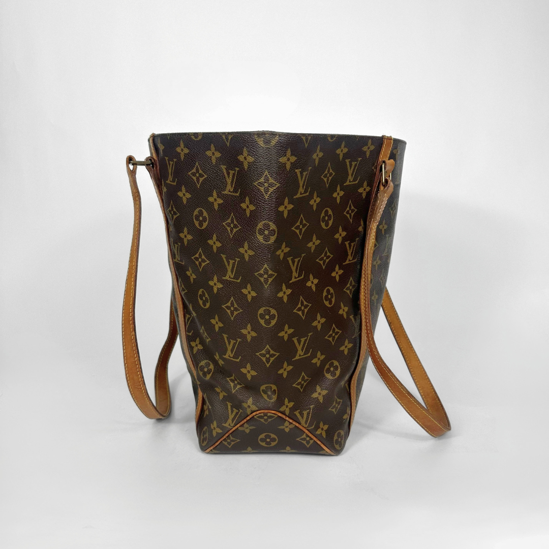 Designer handbag with monogram pattern on a white background