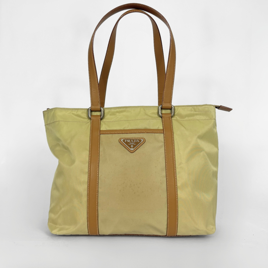 Prada yellow nylon tote bag with tan leather handles and triangle logo.
