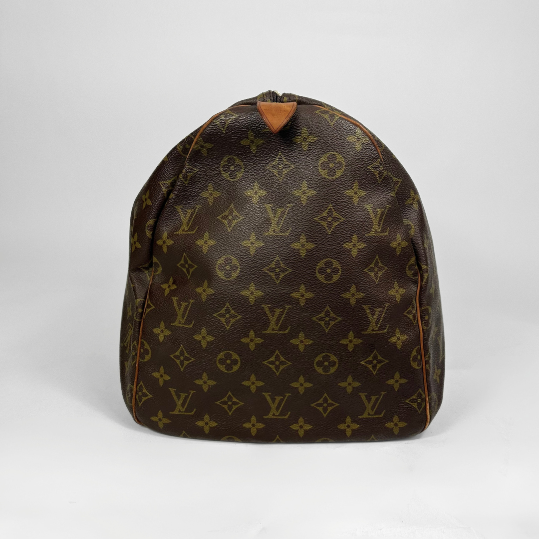 Brown backpack with monogram pattern on a white background