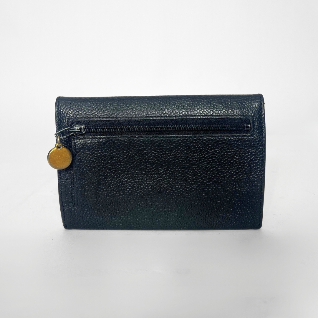 Navy leather wallet with a gold zipper pull on a white background