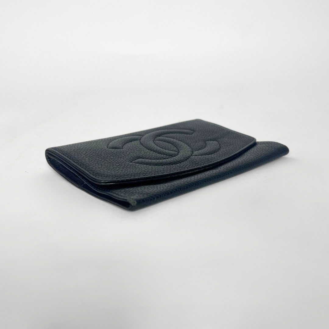 Black textured wallet on a light gray background