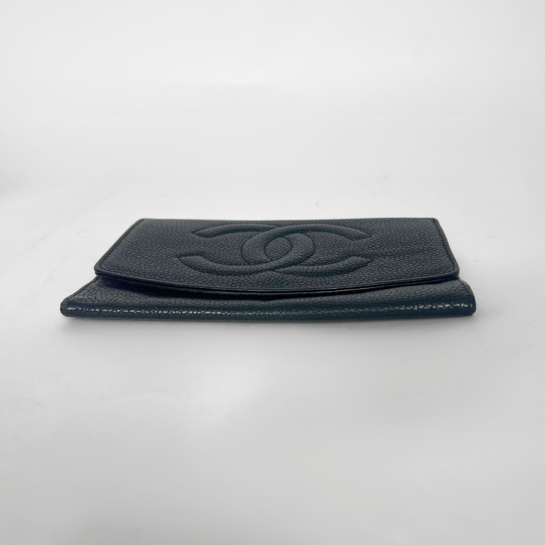 Black leather wallet with Chanel logo on a light gray background