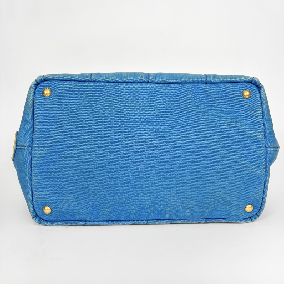 Blue Prada handbag on a white background
