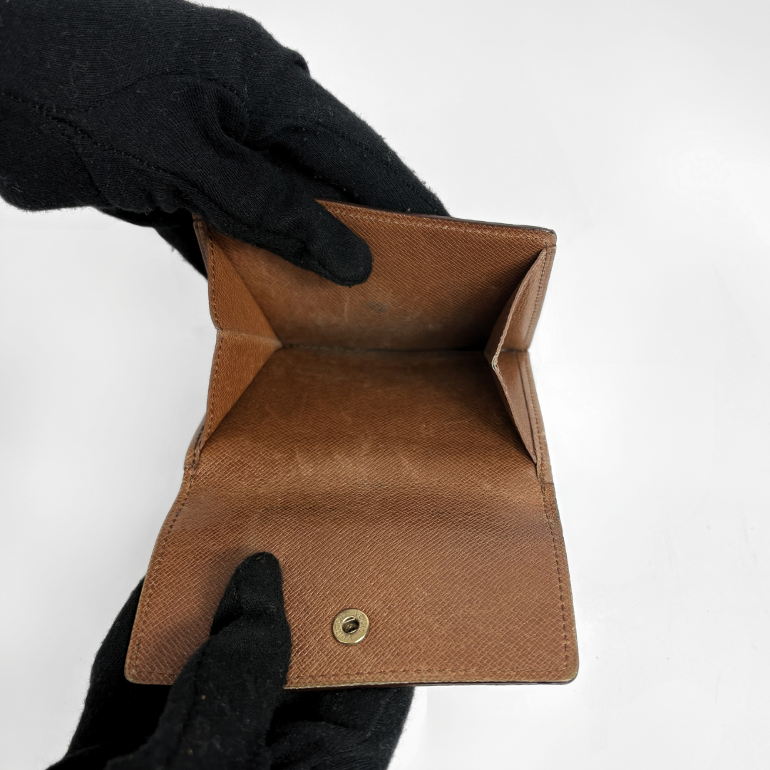 Louis Vuitton Druk Wallet on a white background