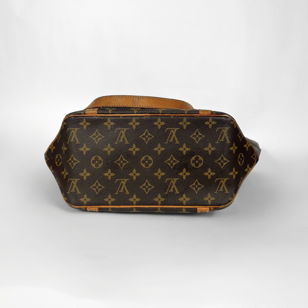 Designer handbag with monogram pattern on a white background