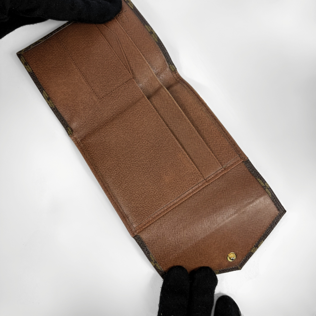 Louis Vuitton Druk Wallet on a white background
