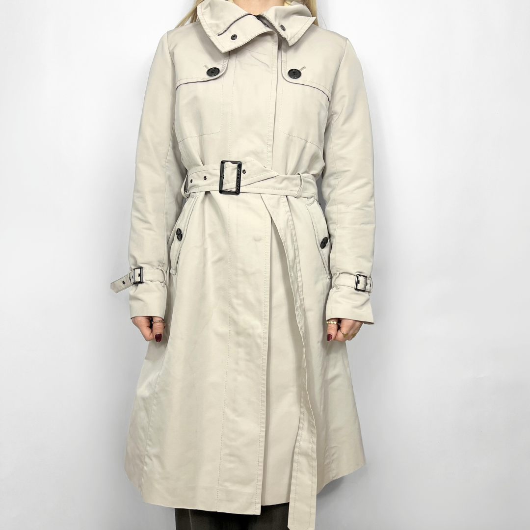 Beige trench coat with a belt on a white background