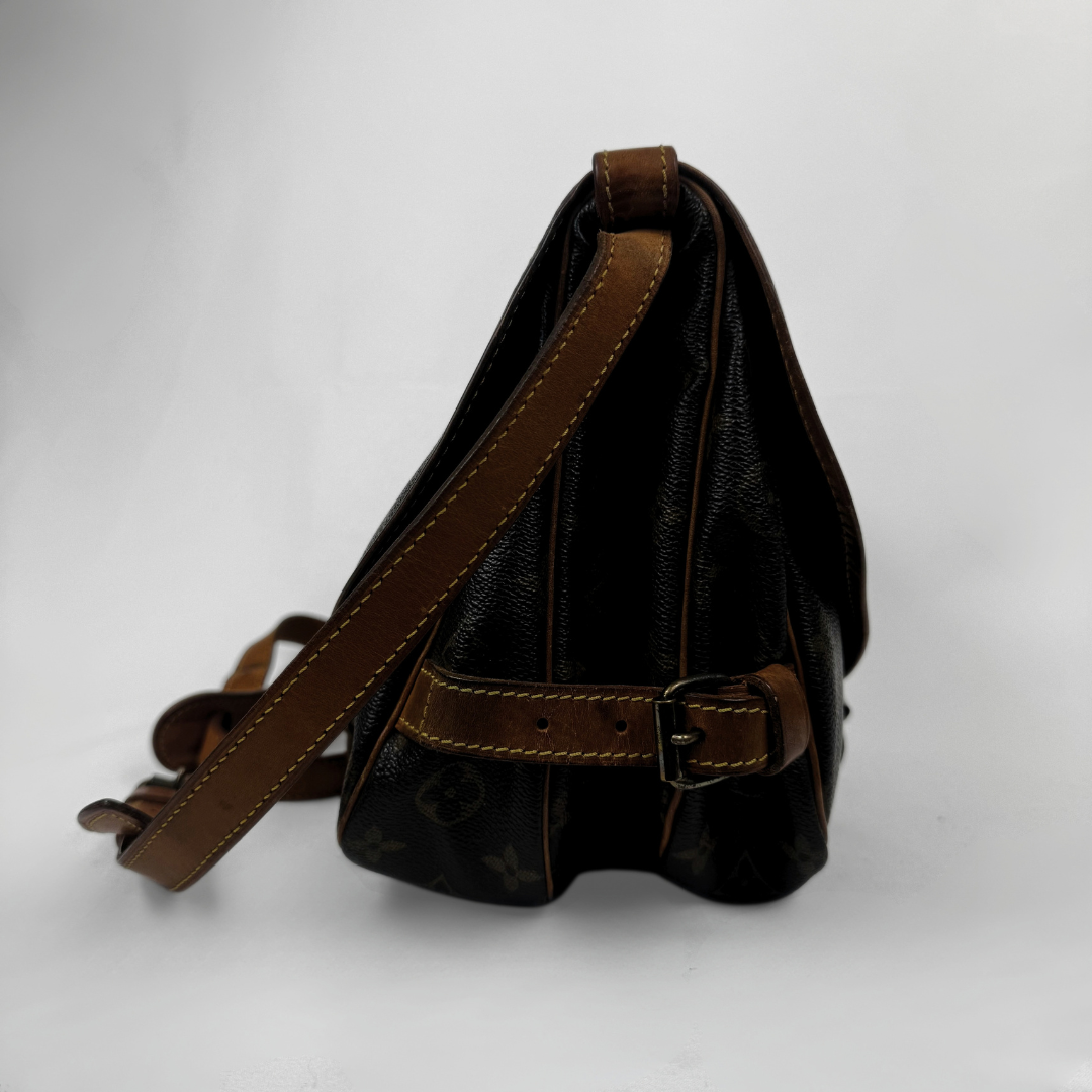 A Louis Vuitton shoulder bag in dark brown monogram canvas with tan leather trim and strap, shown from a side profile view on a light gray background.