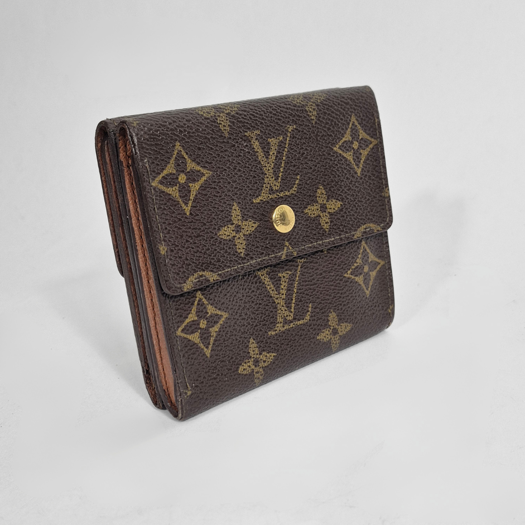 Brown wallet with gold monogram pattern on a light gray background