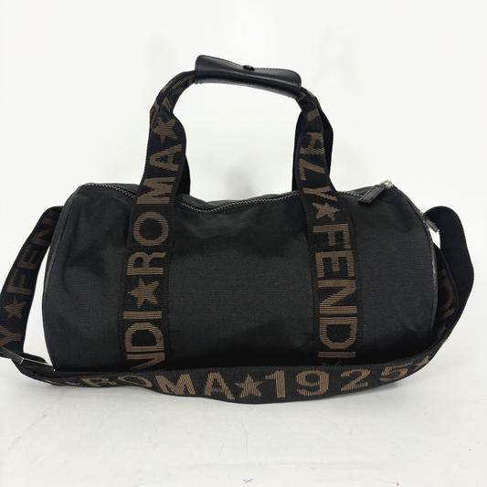 Black duffel bag with branded strap on a white background
