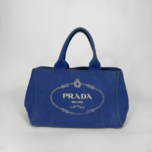 Blue Prada handbag on a light gray background
