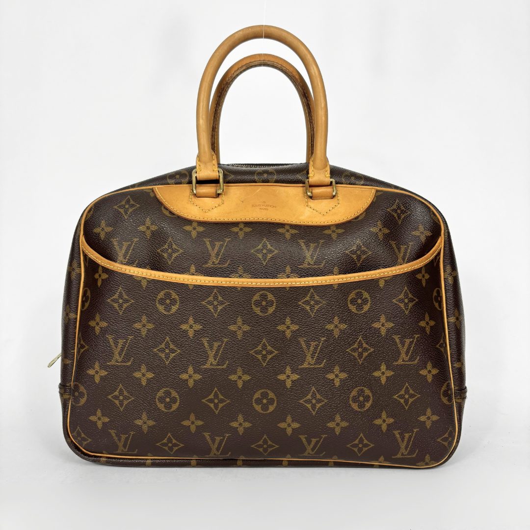 Designer handbag with monogram pattern on a white background