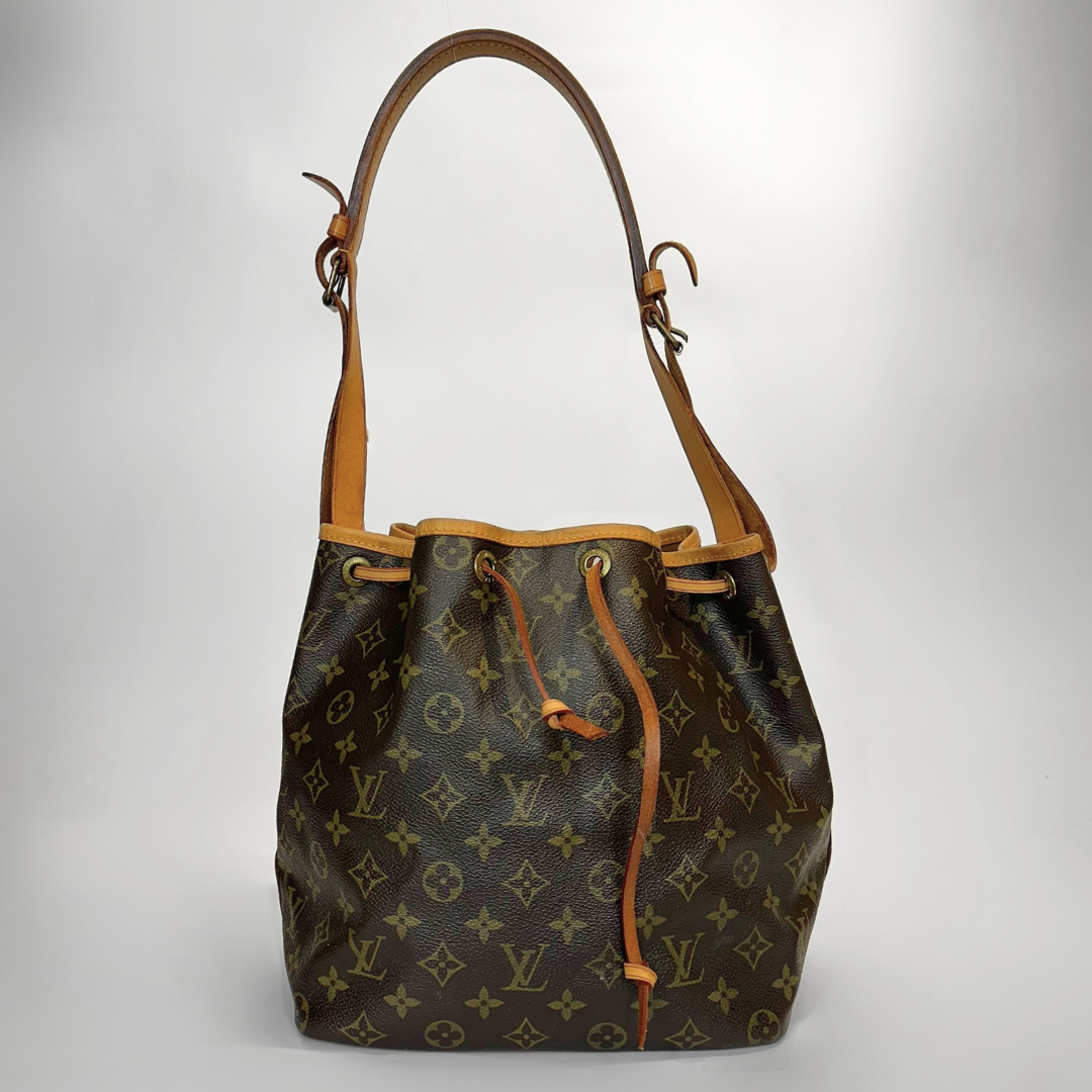 Designer handbag with monogram pattern on a light gray background