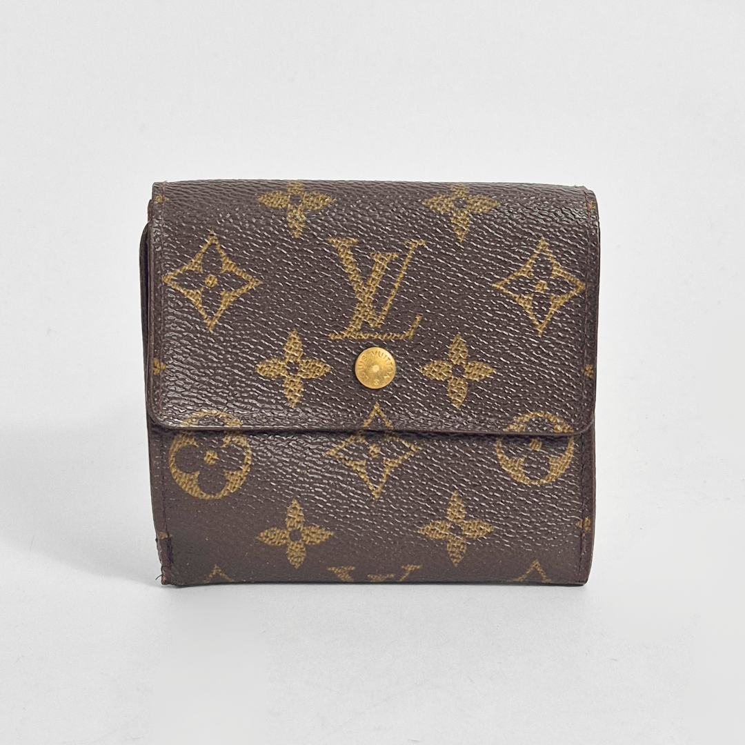 Brown wallet with gold monogram pattern on a light gray background