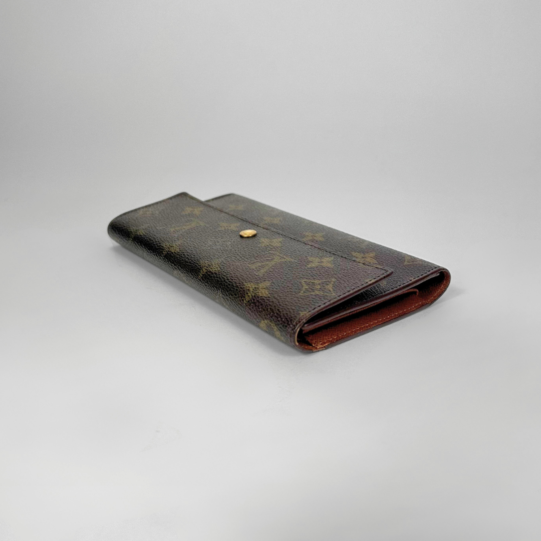 Brown wallet with pattern on a gray background
