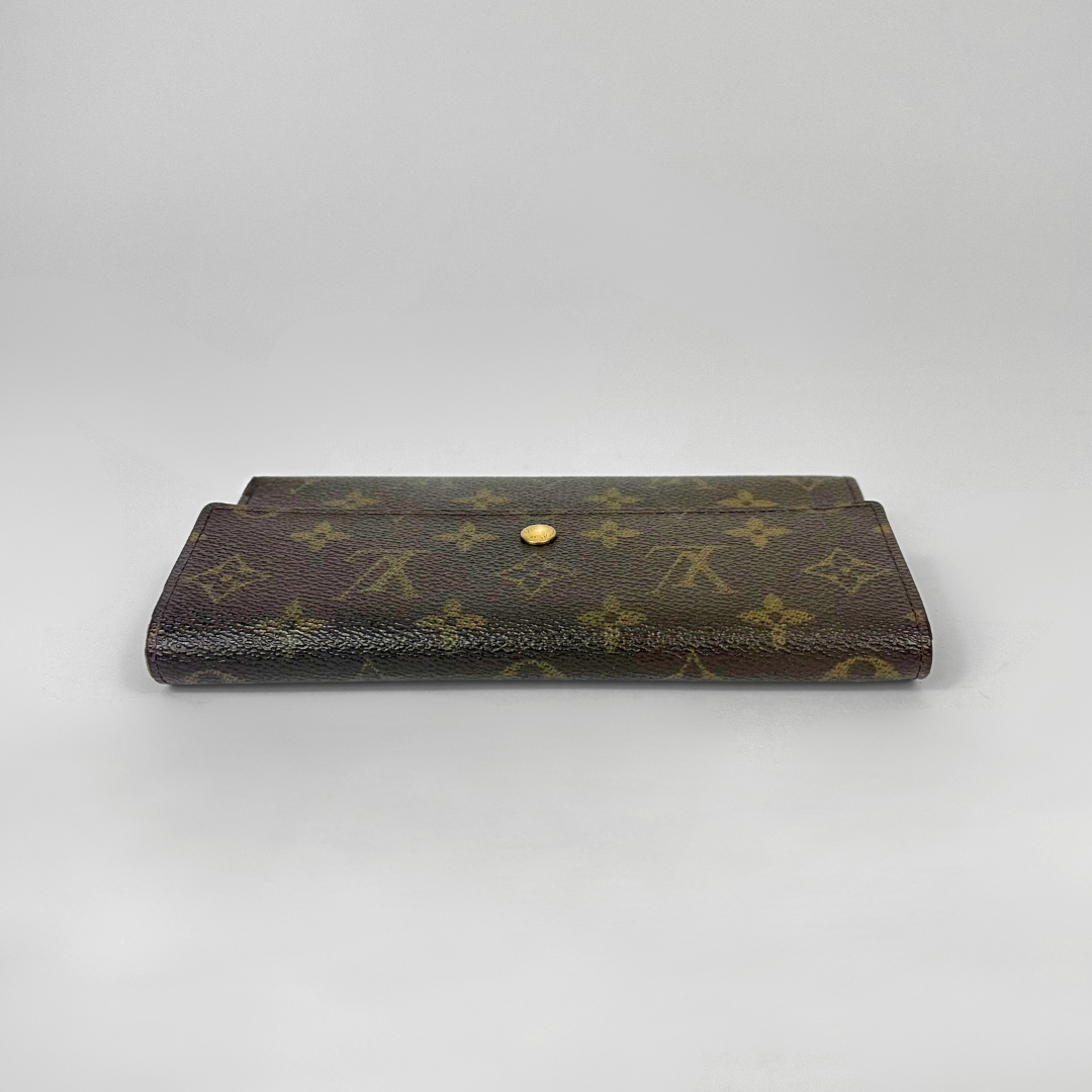Brown wallet with gold accents on a light gray background