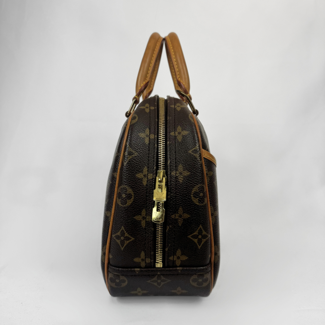 Louis Vuitton monogram canvas handbag with tan leather handles and trim, featuring a gold-tone front zipper, shown against a plain white background.
