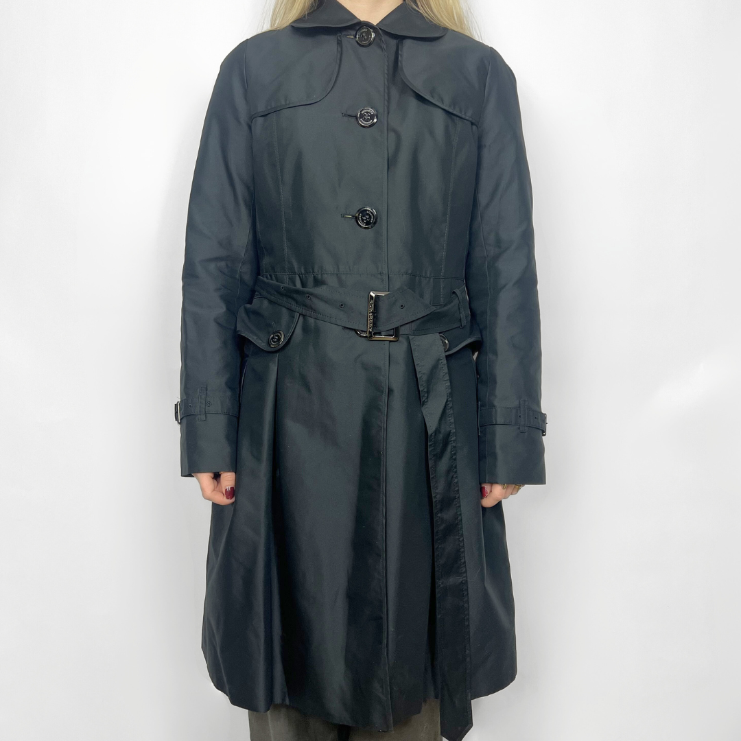 Dark gray trench coat worn by a person on a white background