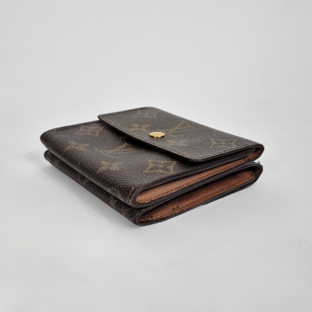Folded brown leather wallet with gold accents on a light gray background
