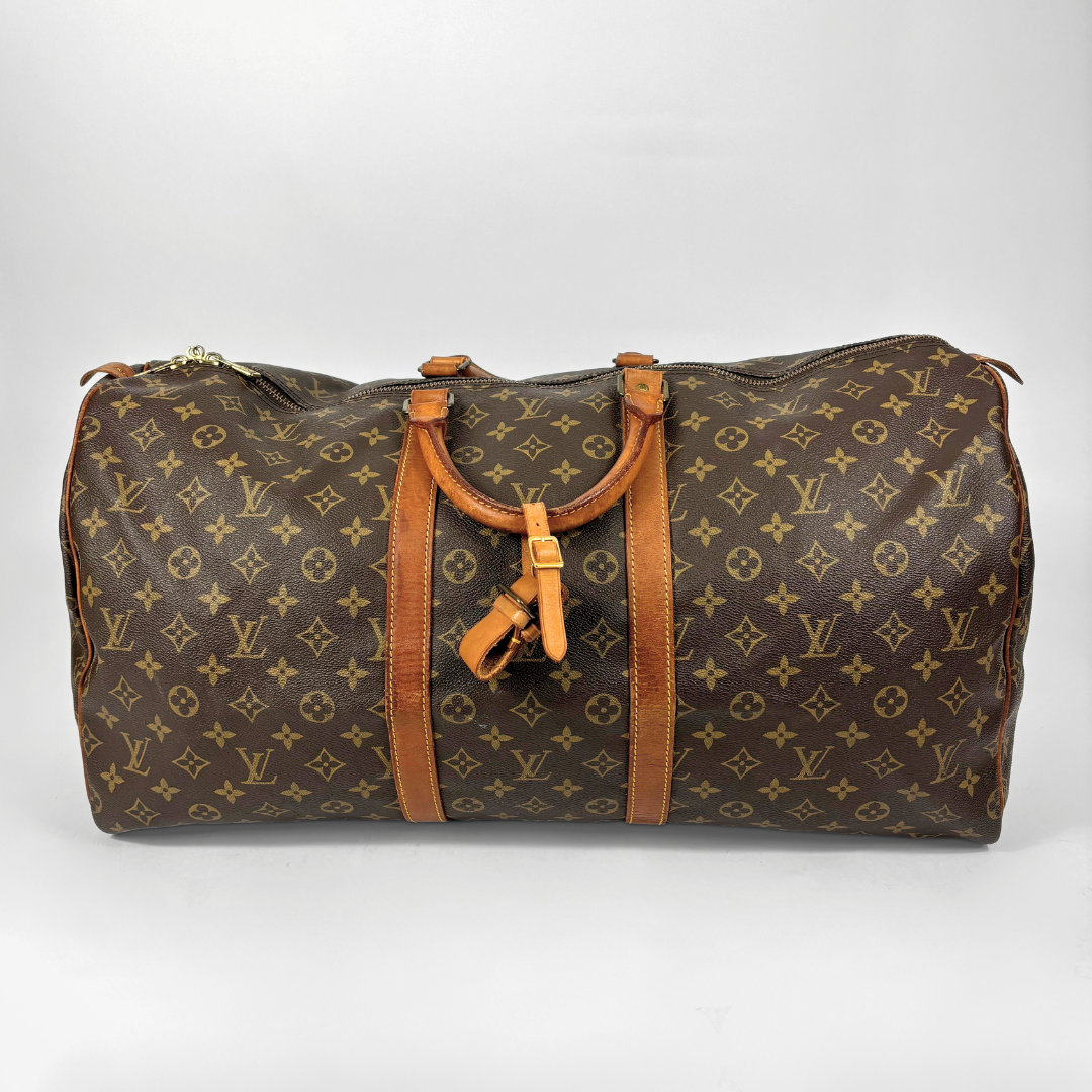 Brown Louis Vuitton travel bag with monogram pattern on a white background