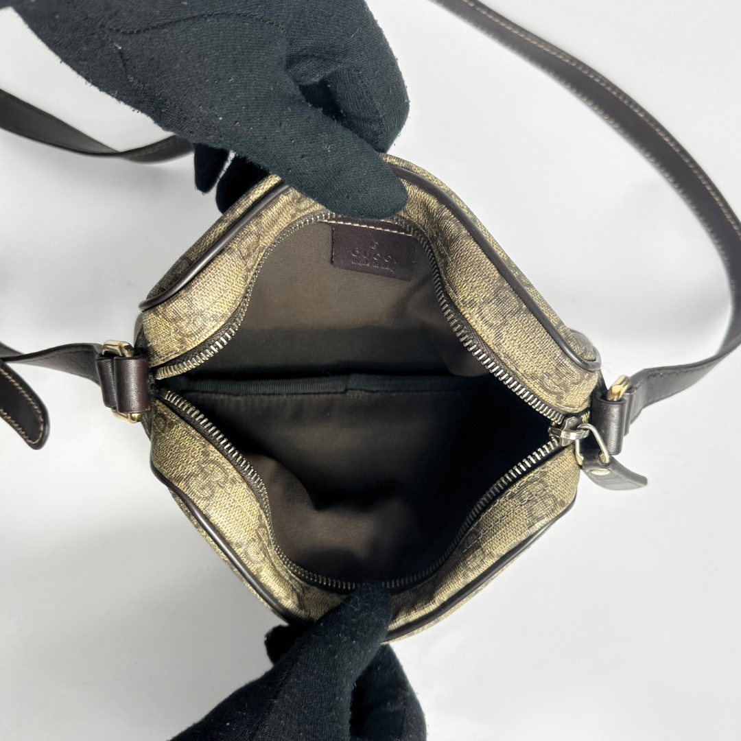 Gucci handbag with monogram pattern on a white background