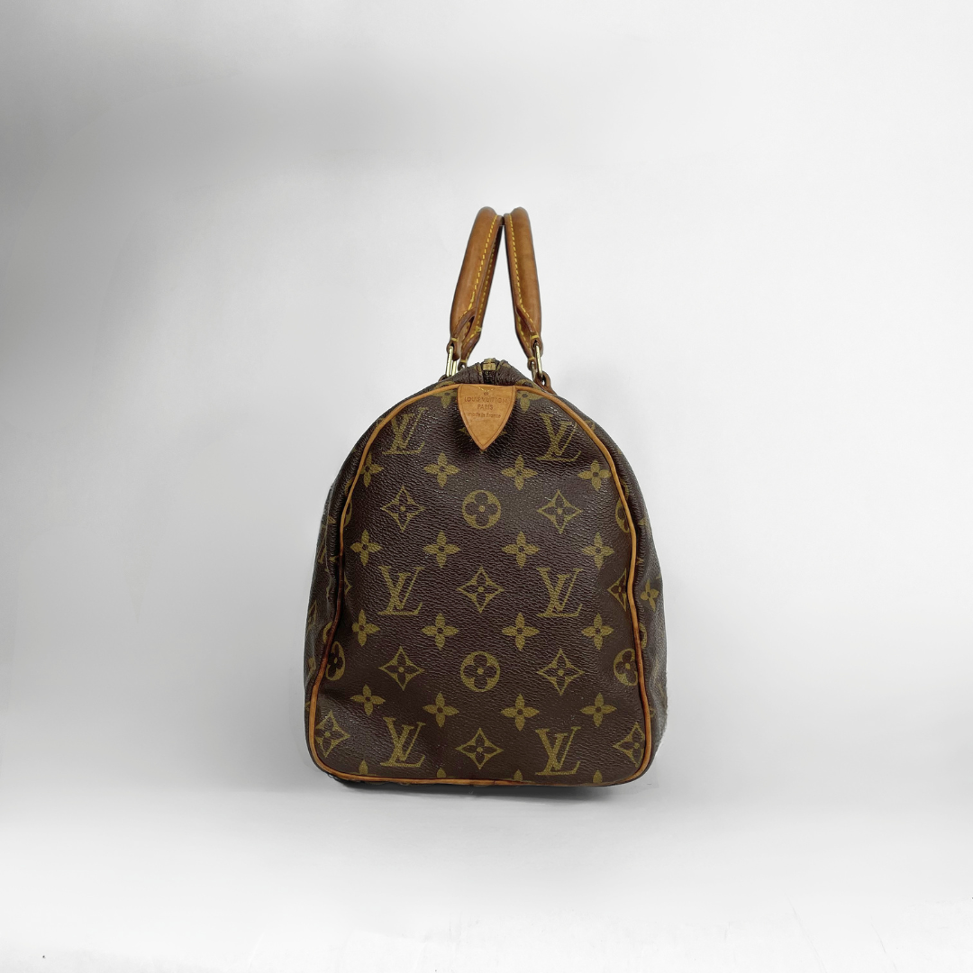 A Louis Vuitton monogram canvas backpack in brown with tan leather handles and trim, photographed against a light gray studio background.