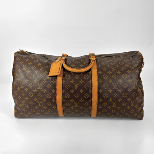 Brown Louis Vuitton travel bag with monogram pattern on a white background