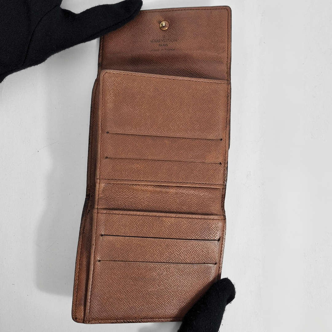 Brown leather wallet with visible brand logo on a white background
