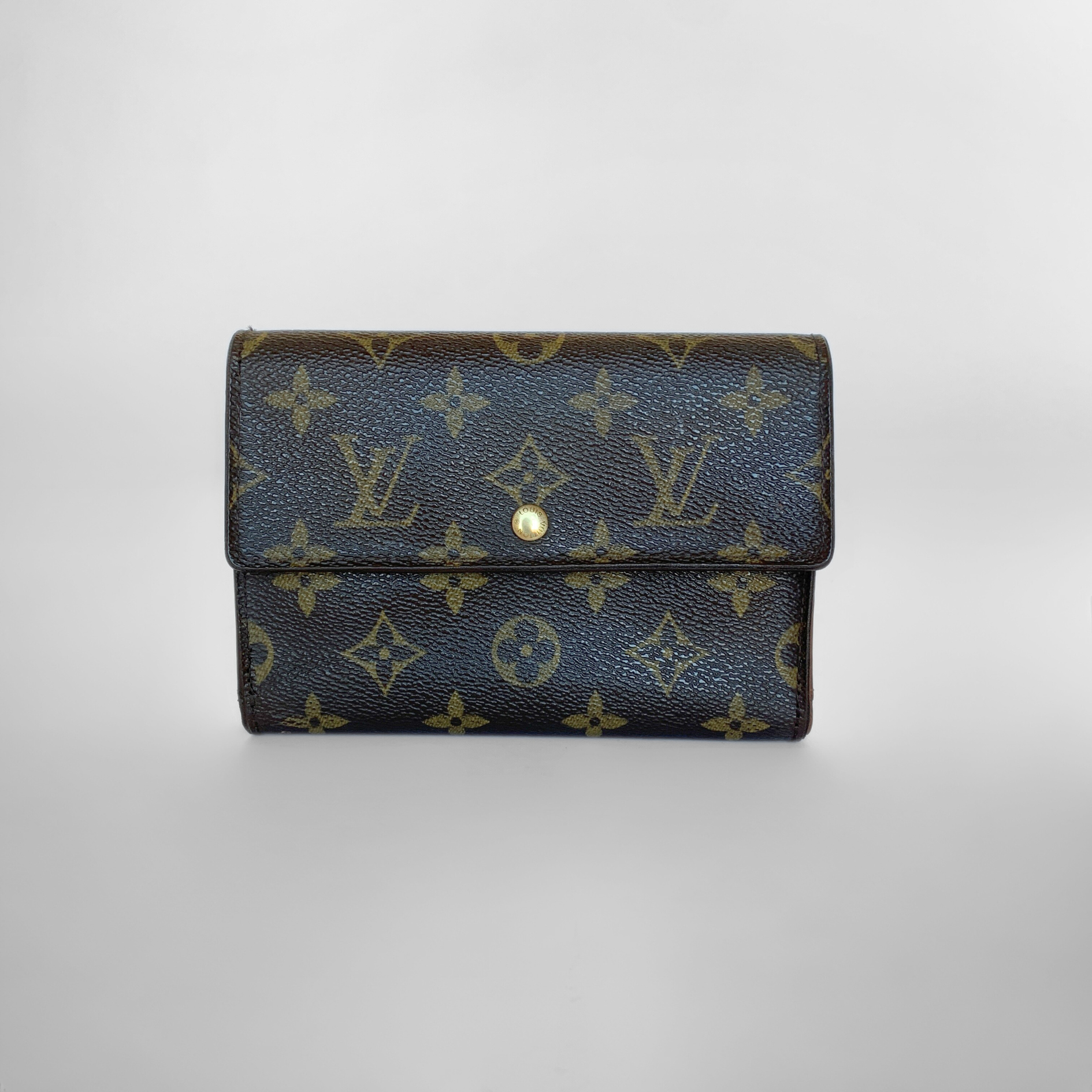 Louis Vuitton wallet with monogram pattern on a light gray background