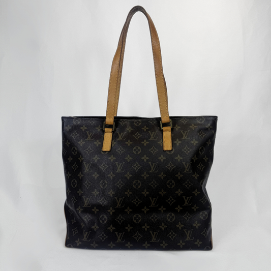 A Louis Vuitton black monogram canvas tote bag with tan leather shoulder straps, shown against a plain light gray background.