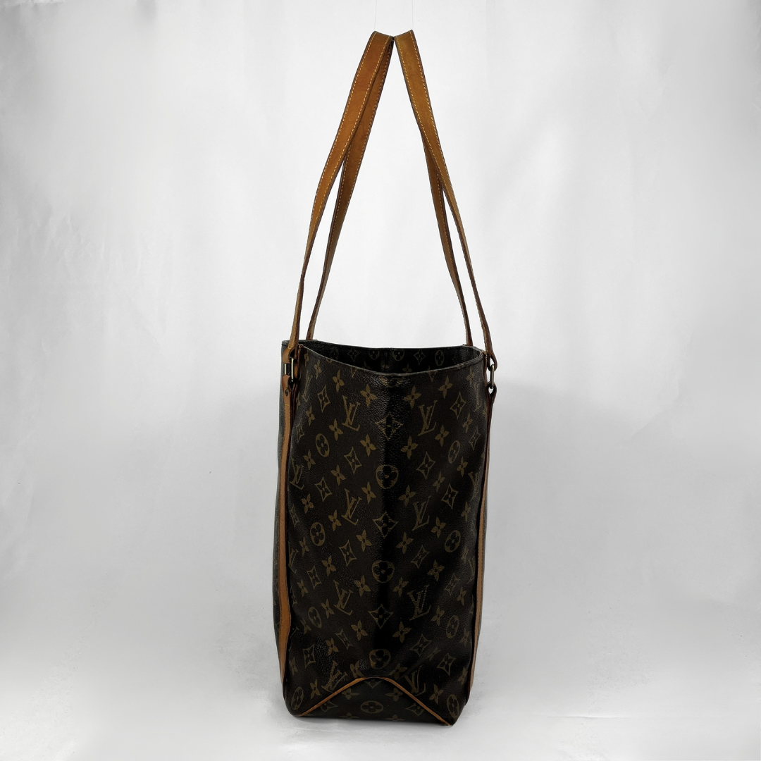 A Louis Vuitton monogram canvas tote bag with brown leather shoulder straps, shown against a plain white background.