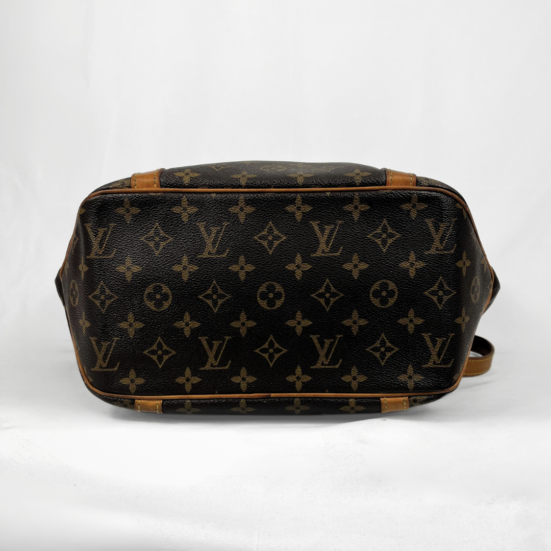 Louis Vuitton monogram canvas shoulder bag shown from the bottom, featuring dark brown coated canvas with tan monogram motifs and light brown leather trim, photographed against a white background.