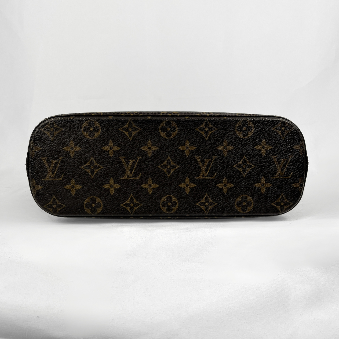 Louis Vuitton monogram canvas pouch in dark brown and tan, photographed against a white fabric background.