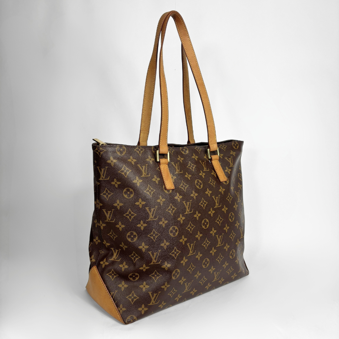 Louis Vuitton monogram canvas tote bag with tan leather shoulder straps and trim, shown on a light gray background.
